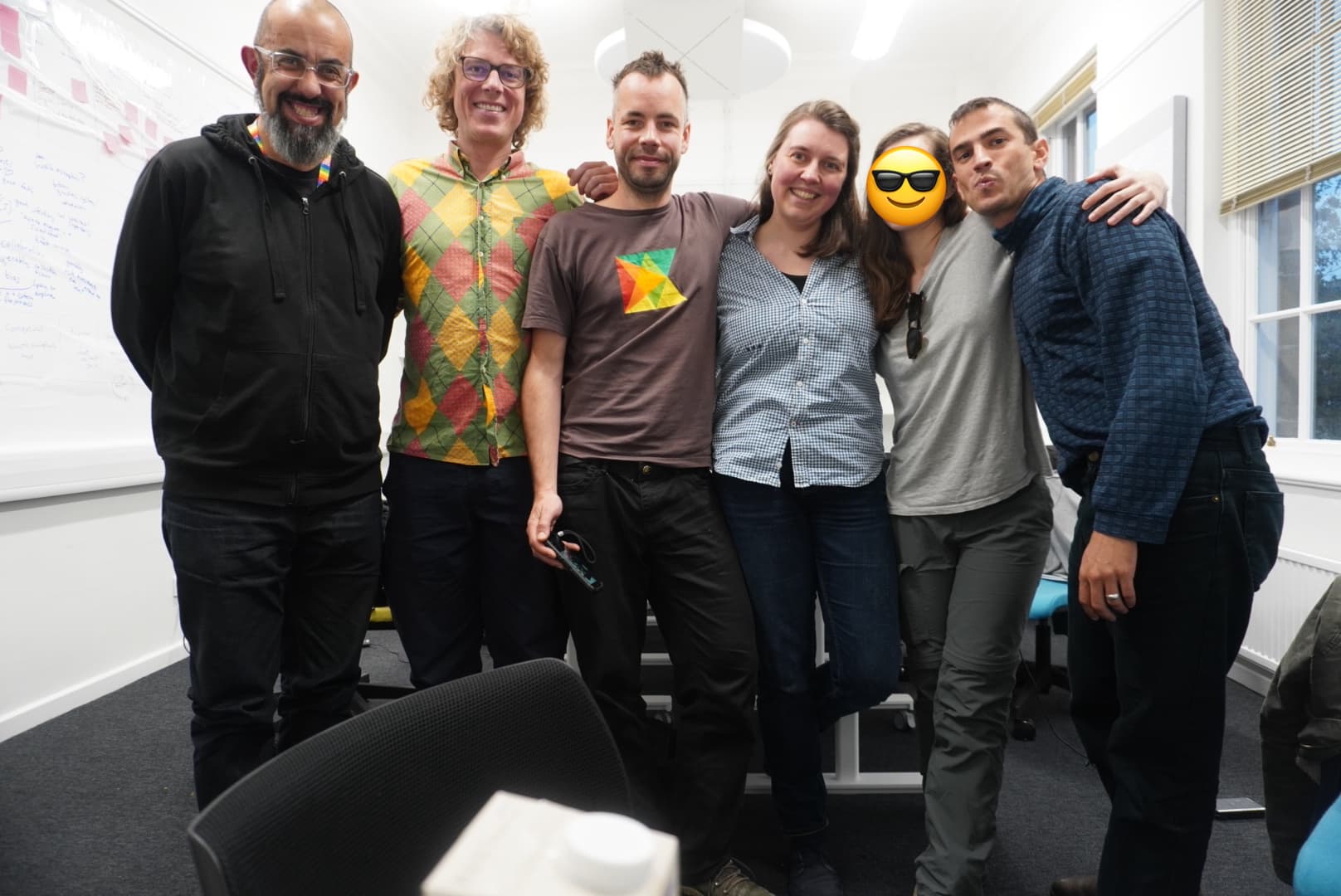 5 members of Karrot in a white and black meeting room posing for a photo
