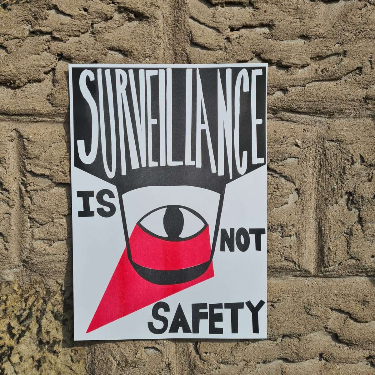 a poster made by a survivor in black white and red that says surveillance is not safety